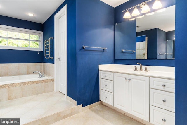 bathroom with vanity, tile patterned floors, and tiled tub