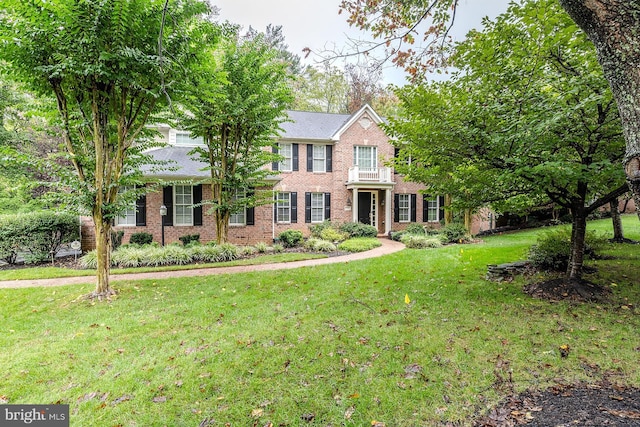 colonial-style house with a front yard