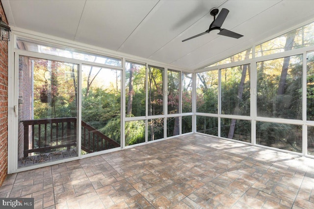 unfurnished sunroom featuring lofted ceiling and ceiling fan