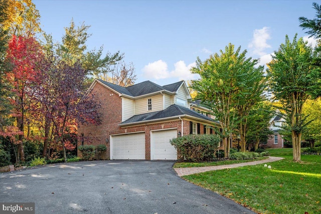 view of front of home featuring a garage and a front yard