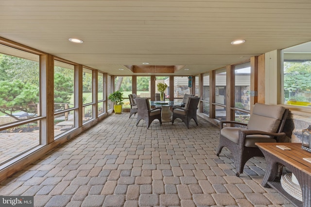 unfurnished sunroom featuring wood ceiling