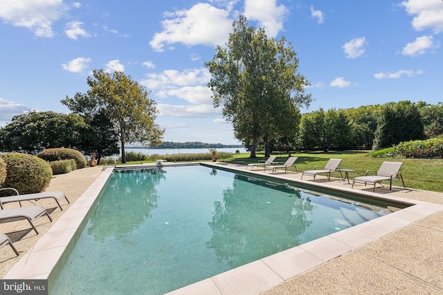 view of swimming pool with a yard, a water view, and a patio