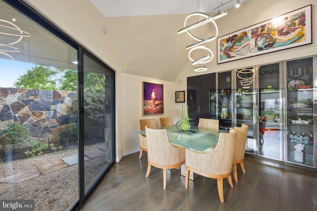 dining area with dark wood-type flooring and a chandelier