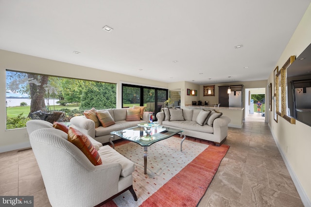 living room with a healthy amount of sunlight and french doors