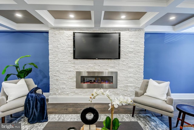 living room with hardwood / wood-style flooring, beam ceiling, coffered ceiling, a fireplace, and crown molding