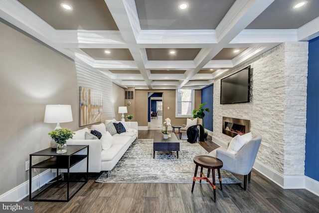 living room with coffered ceiling, a stone fireplace, dark hardwood / wood-style flooring, beamed ceiling, and ornamental molding