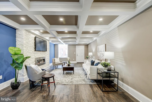 living room with beam ceiling, coffered ceiling, a fireplace, dark hardwood / wood-style flooring, and ornamental molding