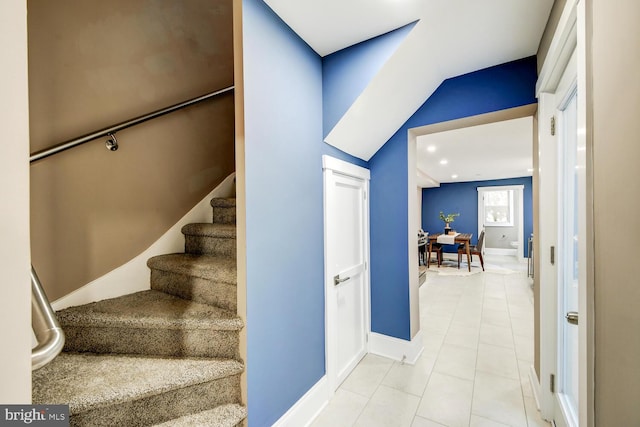 stairway with tile patterned floors