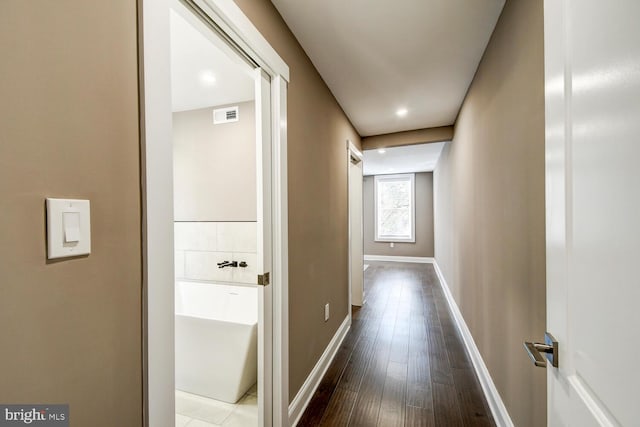 hallway with wood-type flooring