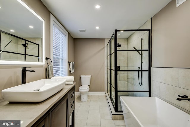 full bathroom with tile patterned flooring, vanity, toilet, and plus walk in shower