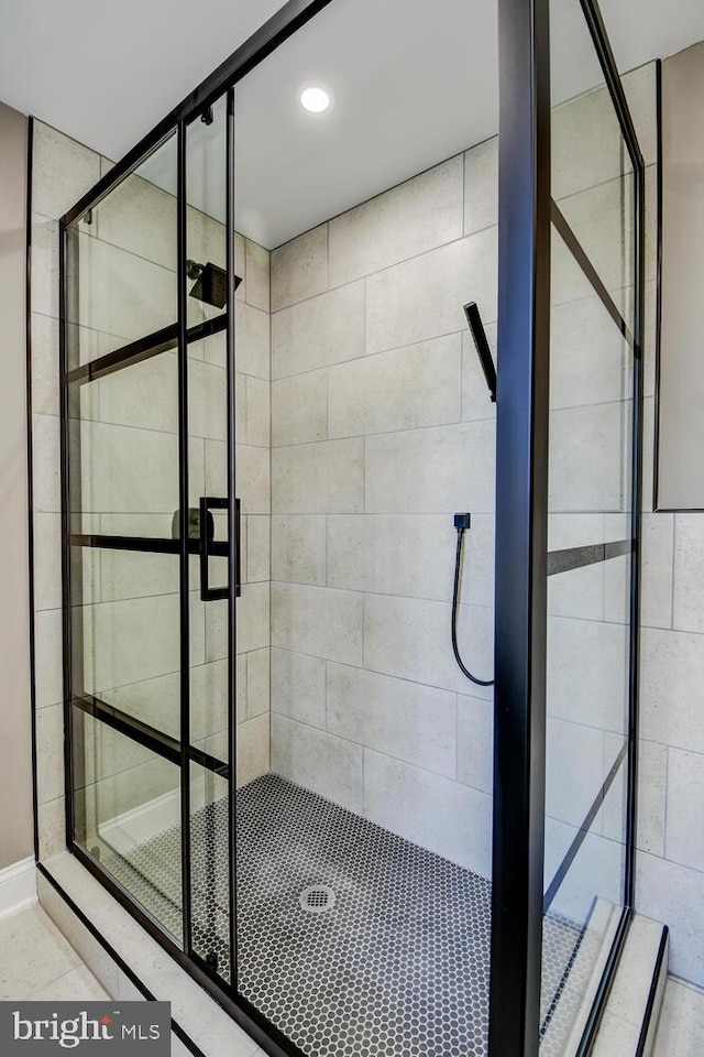 bathroom with a shower with door