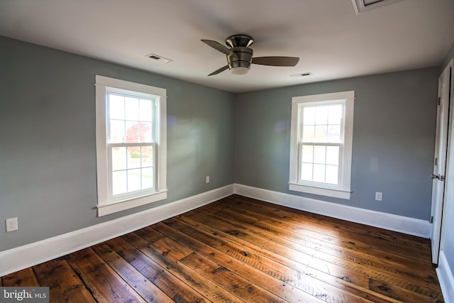 unfurnished room featuring baseboards, a healthy amount of sunlight, and visible vents