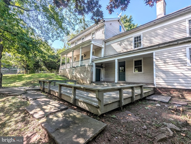 rear view of property with a wooden deck