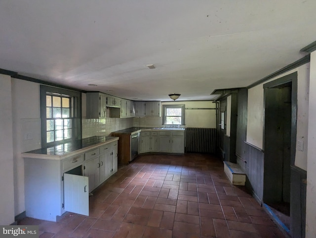 kitchen with decorative backsplash, stainless steel dishwasher, ornamental molding, and sink