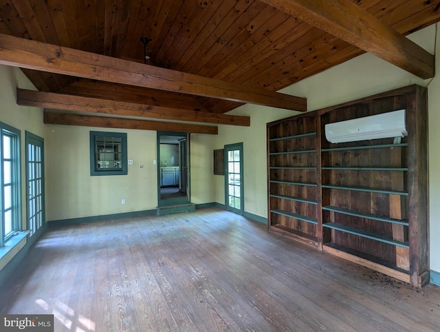 empty room with beamed ceiling, hardwood / wood-style floors, a wall mounted air conditioner, and wooden ceiling