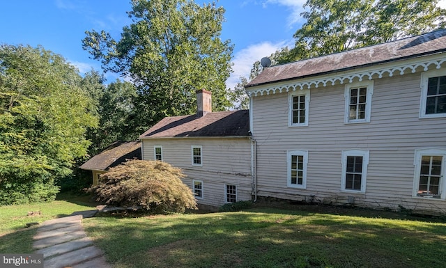 view of side of home featuring a lawn