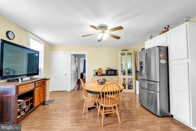 dining room featuring light hardwood / wood-style floors and ceiling fan