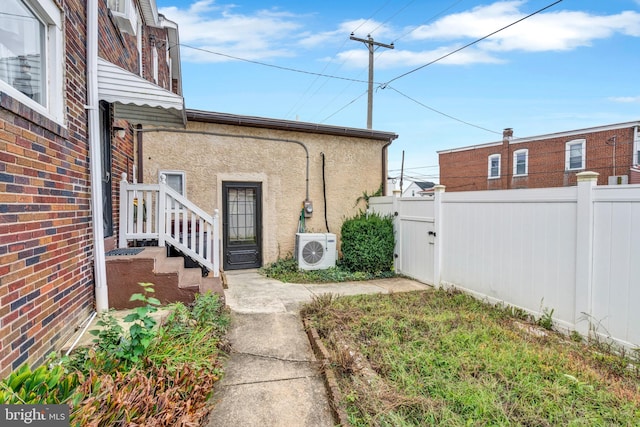 view of exterior entry with ac unit