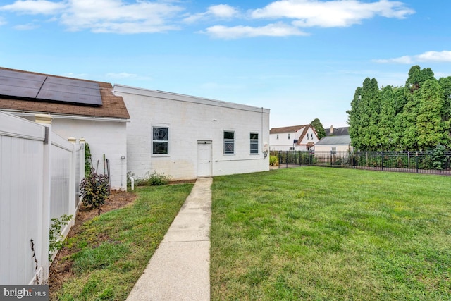 rear view of property featuring a yard