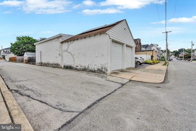 exterior space featuring an outbuilding and a garage