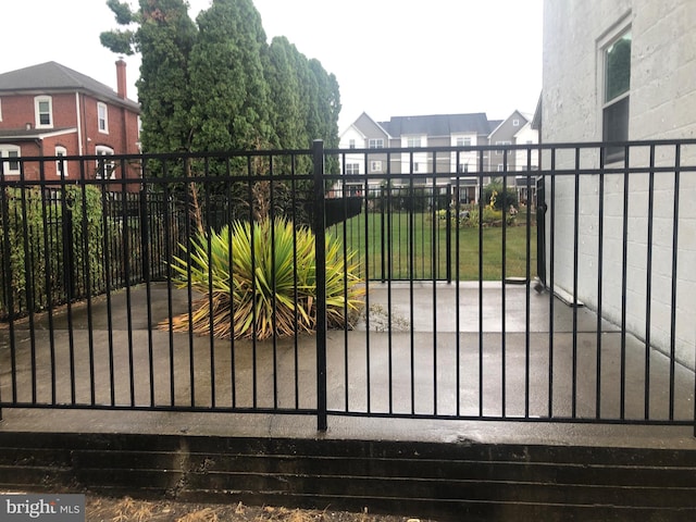 view of gate featuring a yard