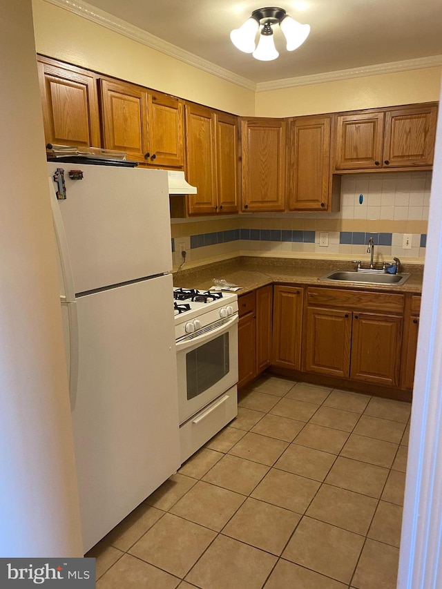 kitchen with crown molding, decorative backsplash, sink, and white appliances