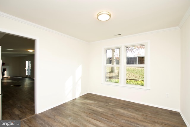 empty room with crown molding and dark wood-type flooring