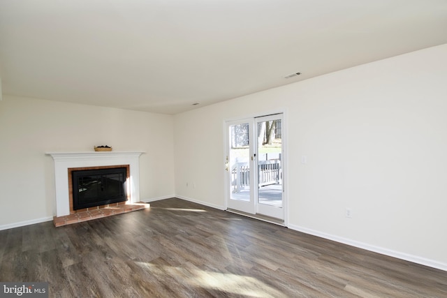 unfurnished living room with a fireplace and dark wood-type flooring