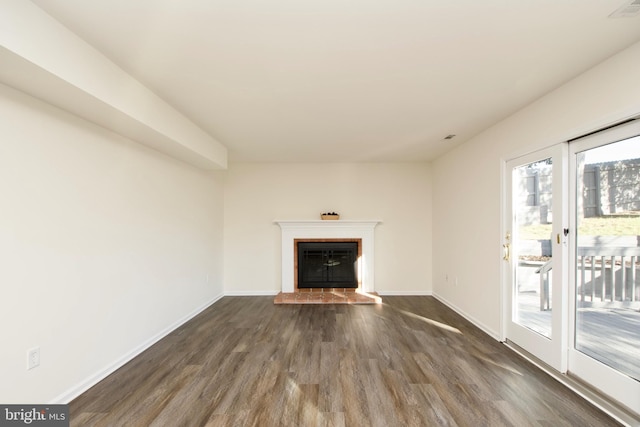 unfurnished living room with dark hardwood / wood-style flooring