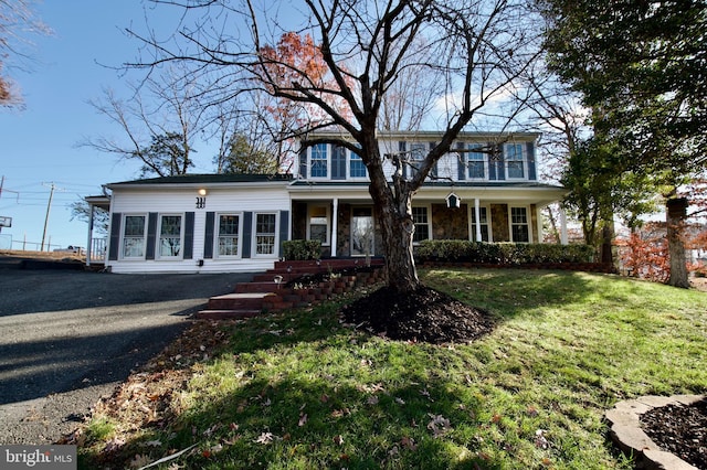 view of front of home with covered porch and a front yard