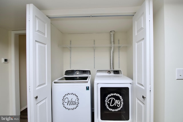 clothes washing area with hardwood / wood-style floors and separate washer and dryer