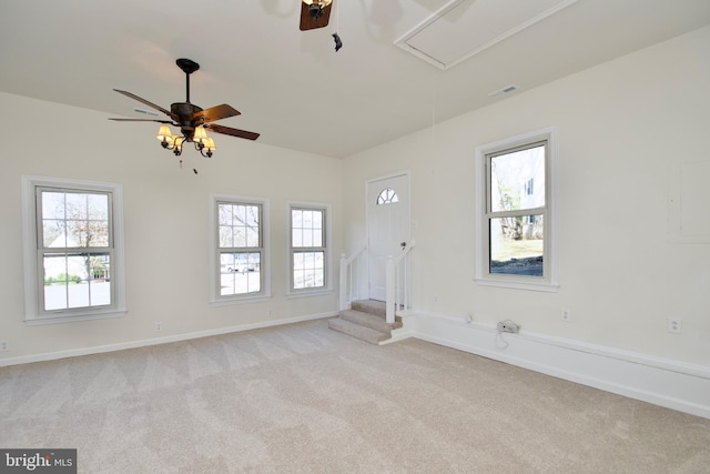 carpeted spare room featuring ceiling fan