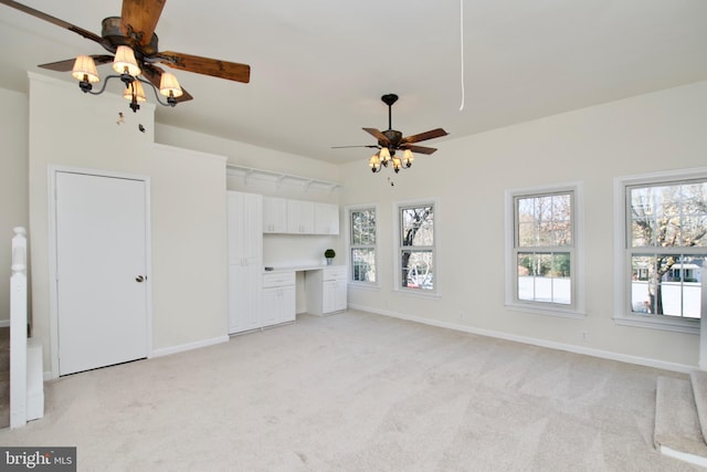 unfurnished living room with ceiling fan and light carpet