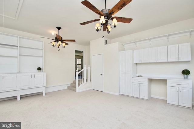 unfurnished living room with ceiling fan and light colored carpet