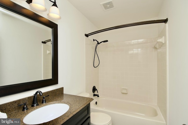 full bathroom with vanity, toilet, and tiled shower / bath