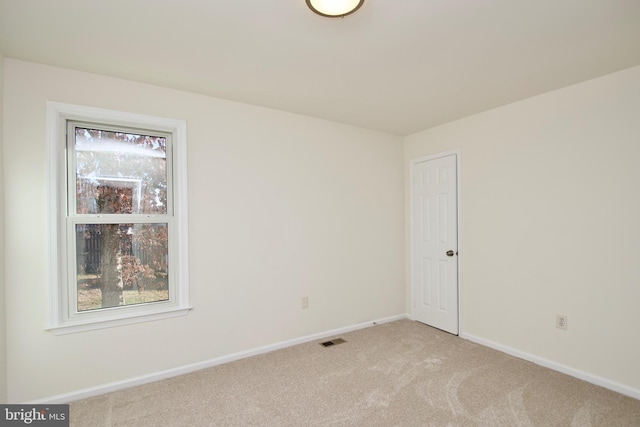 empty room featuring light colored carpet