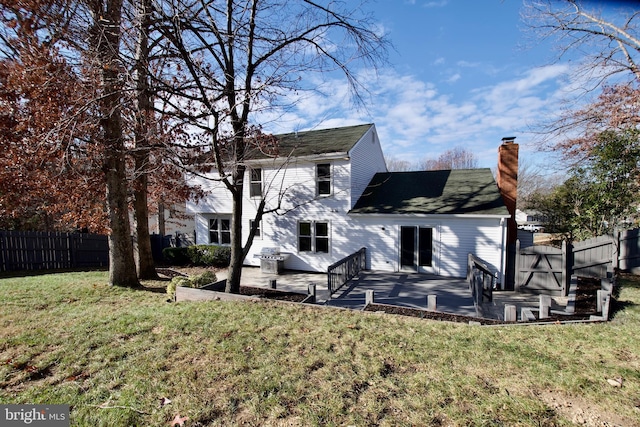 back of property with a lawn and a storage unit