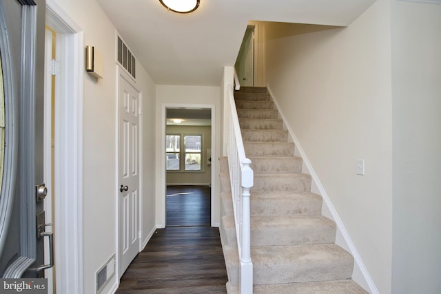 stairway with hardwood / wood-style flooring