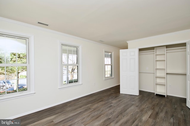 unfurnished bedroom with dark hardwood / wood-style flooring and ornamental molding