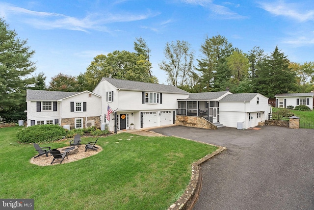 view of front of house with a front yard and a garage