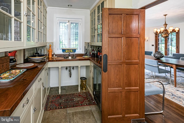 94 N Rd, Princeton, NJ 08540 - kitchen featuring backsplash, glass insert cabinets, wooden counters, and an inviting chandelier