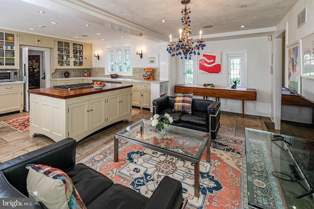 living room featuring ornamental molding and an inviting chandelier