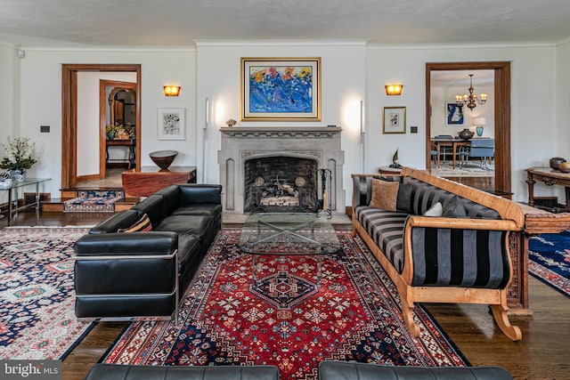 living room with crown molding, an inviting chandelier, and dark hardwood / wood-style flooring