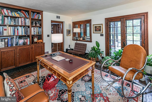 office space with french doors and a textured ceiling