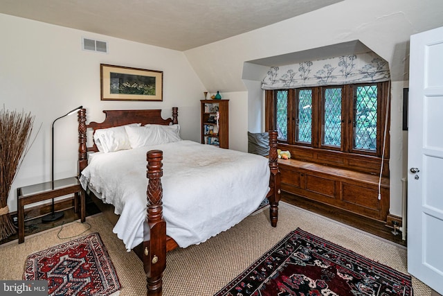 bedroom with lofted ceiling and carpet floors