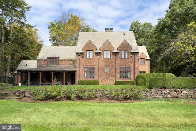 94 N Rd, Princeton, NJ 08540 - tudor-style house featuring brick siding, a chimney, and a front yard
