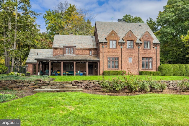 back of house with a lawn