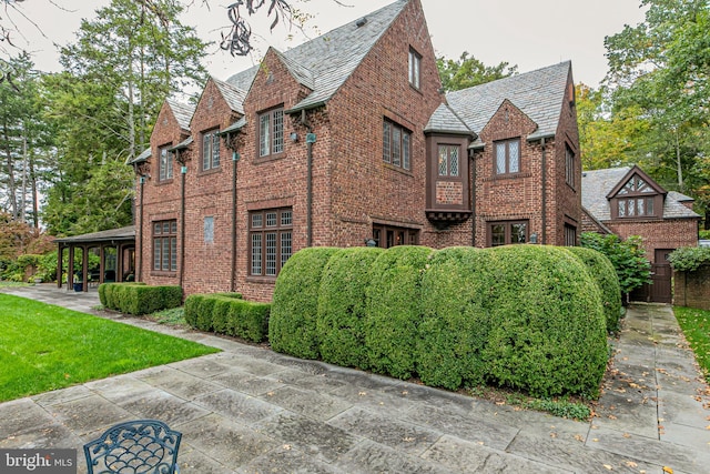 view of side of property with a lawn