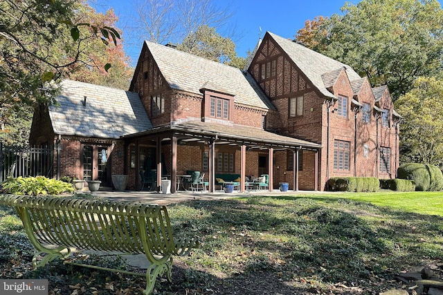 back of house featuring a yard and a patio area