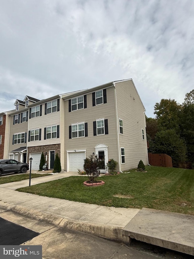 view of property with a front yard and a garage